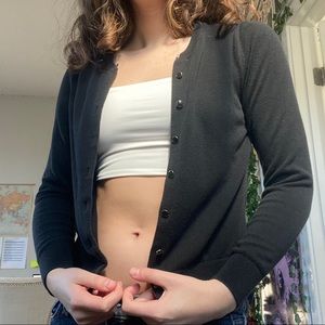 black cardigan with gold/black buttons